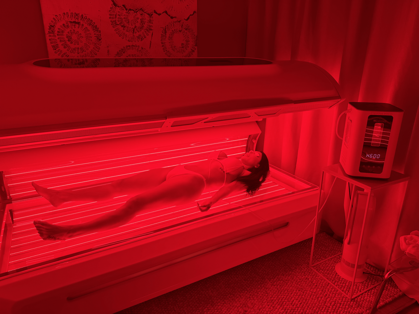Guest receiving Full Body LED Photobiomodulation Therapy inside the ETERNA HAUS red light bed