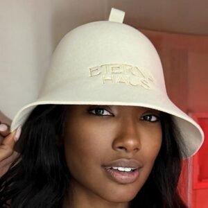 Woman wearing the ETERNA HAUS 100% Merino Wool Sauna Hat, close-up